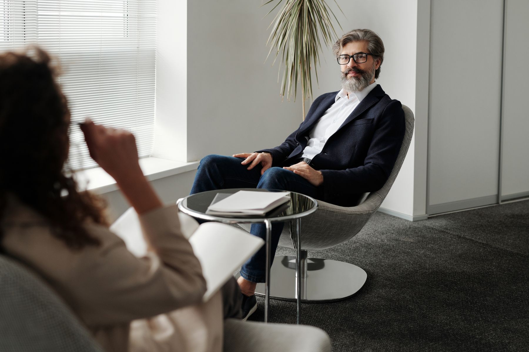 Professional adviser speaking with a client in a bright office