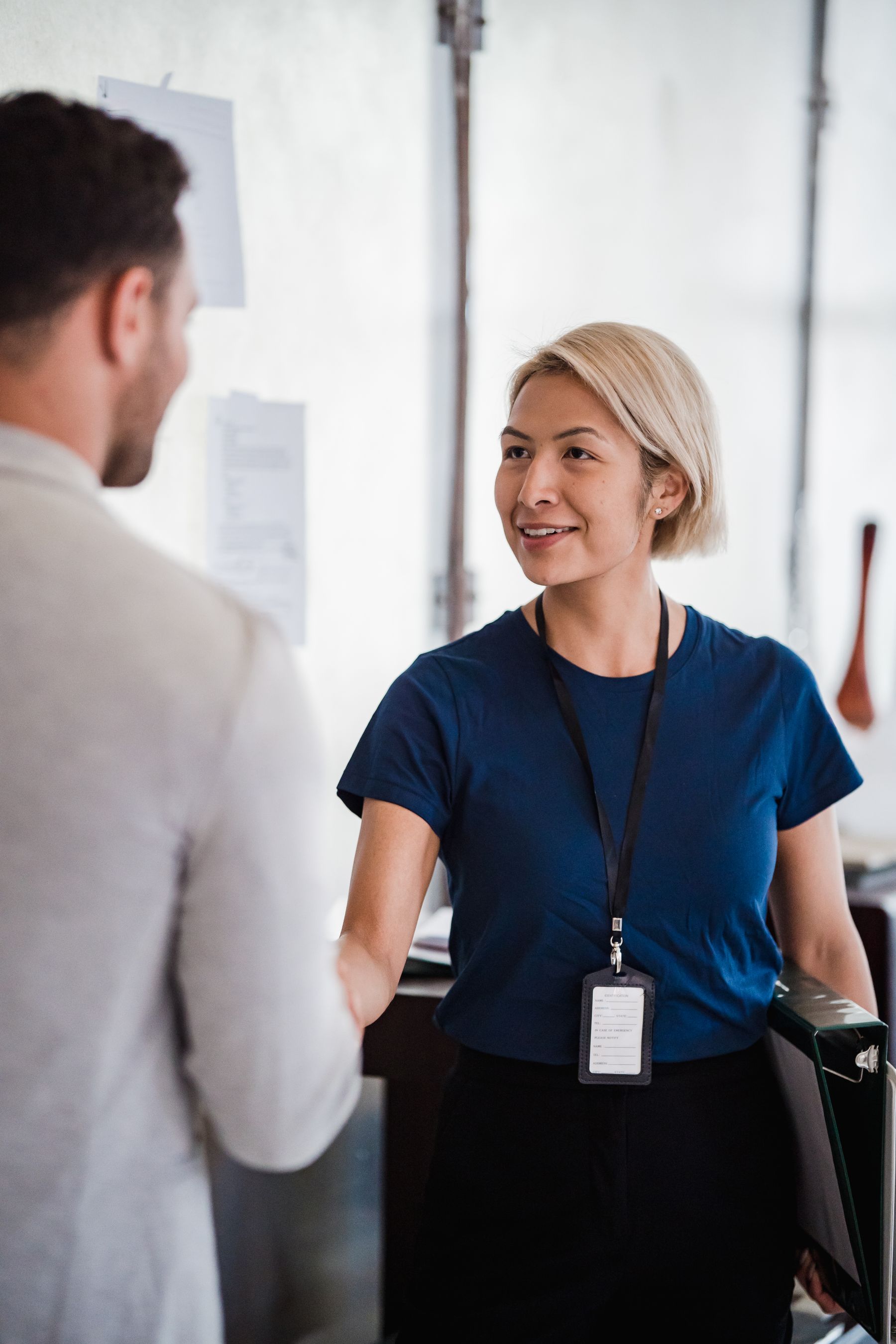 Two professionals greeting one another in an office